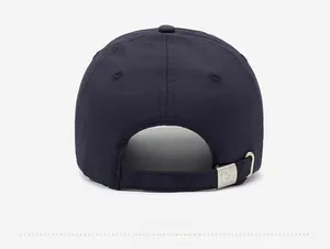 Detail view of the navy baseball cap back featuring an adjustable strap with metal buckle