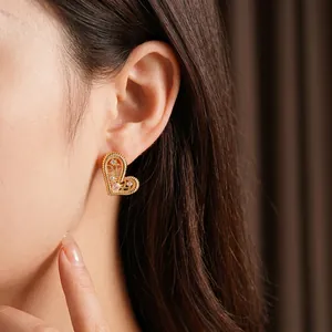 Exquisite gold-plated hollow heart stud earrings with sparkling zircon and woven texture