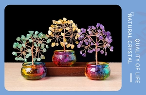 Detailed view of green yellow and purple natural crystal money trees on wooden base