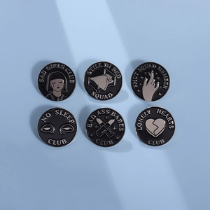 Set of 6 black geometric flame enamel badges featuring various artistic club designs