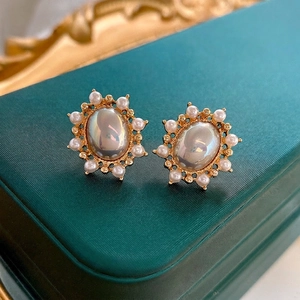 French vintage sunflower pearl earrings with oval iridescent stone on green velvet box