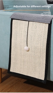 Detail of sisal scratching mat with plush ball on a blue sofa for furniture protection