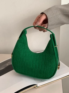 Stylish green felt dumpling bag for women featuring luxury crocodile texture and gold hardware