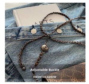 Detail of adjustable retro bronze chain and leather strap with checkered metal ball slider