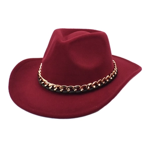 Detail of burgundy wool felt jazz hat featuring a gold chain and black cord decorative band