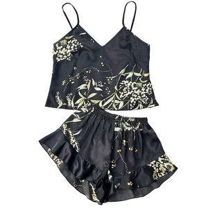 Two-piece black floral satin pajama set with camisole top and ruffled hem shorts