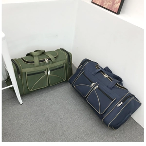 Detail of army green and navy blue Oxford cloth travel bags with multiple zipper pockets