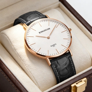 Close-up of classic quartz watch with white dial and black leather strap in gift box