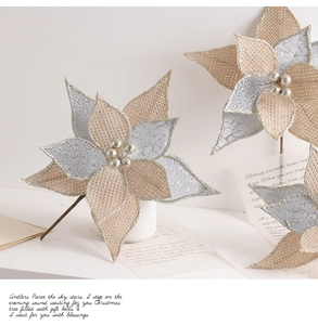 Detail of burlap Christmas flower with silver glitter petals and central pearl beads