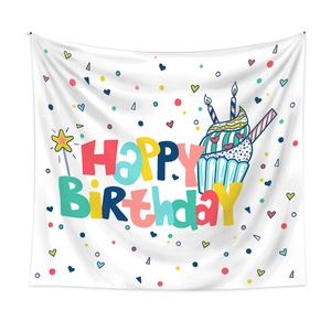 Detail of white birthday tapestry featuring colorful cartoon lettering and cupcake illustration