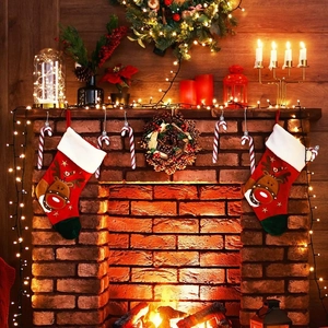Festive fireplace setup with red reindeer stockings and striped candy cane ornaments