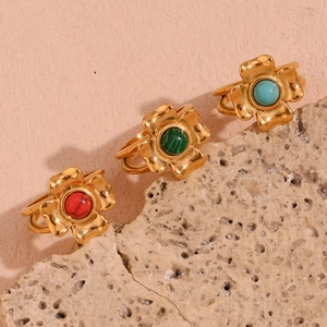 Close-up of 18K gold plated floral rings with red, green, and turquoise stones