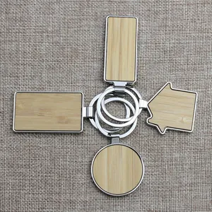 Bamboo and metal keychain set in rectangle round and house shapes on grey background
