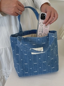 Blue denim mini tote bag with white bow embroidery and canvas handles for women