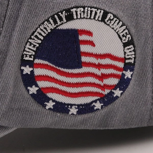 Macro shot of baseball cap featuring a round American-style embroidered patch with slogan