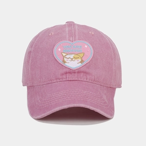 Detail of pink washed cotton baseball cap featuring cat heart embroidery and You Are Enough text