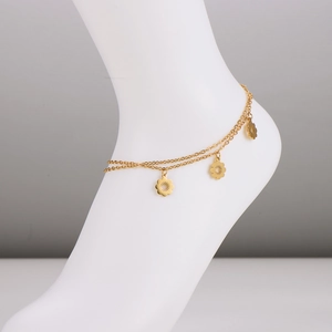 Double-layered gold stainless steel anklet with delicate flower charms in a studio shot