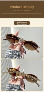 Detail of gold oval frame sunglasses with heart-shaped crystal embellishments