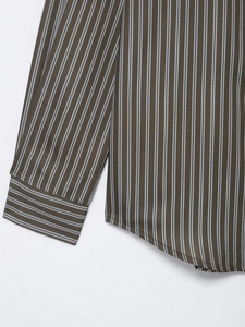 Detail of coffee and blue striped poplin shirt showing neat stitching and curved hem
