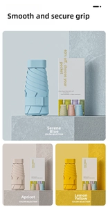 Detail view of ultra-light six-fold mini umbrellas in blue, apricot, and yellow with boxes
