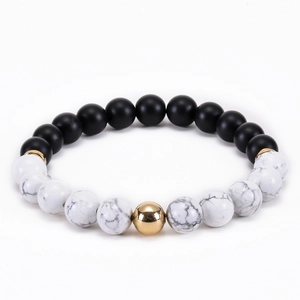 Elastic bead bracelet with matte black beads and white marble stones with gold accents