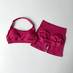 Detail of dark magenta halter sports bra and high-waisted scrunch butt shorts set