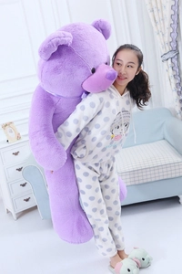 Extra large purple teddy bear plush toy shell shown with model to highlight giant size