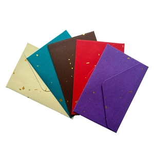 Close-up of mini envelopes in assorted colors with elegant gold foil speckled texture