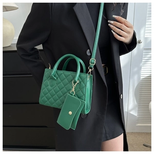 Green quilted faux leather handbag with matching coin purse and golden hardware details