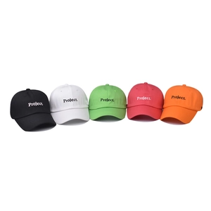 Five assorted cotton baseball caps with Project embroidery in a row on white background