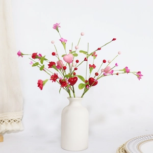 Artificial heart-shaped flower pick with red and pink berries in a white ceramic vase
