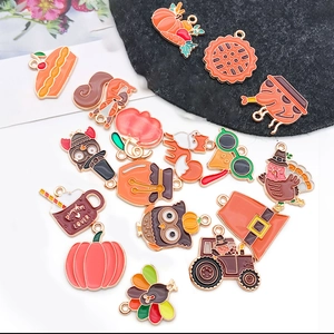 Detailed macro of enamel Thanksgiving charms featuring pumpkins, turkeys and squirrels