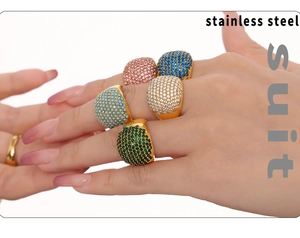 Close-up of hand wearing 18K gold plated stainless steel rings with colorful zircon inlay