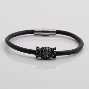 Black leather bracelet with crown bead and magnetic buckle in central studio view