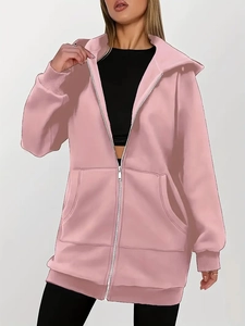 Close-up of pink zip-up hoodie featuring ribbed cuffs and large front pockets