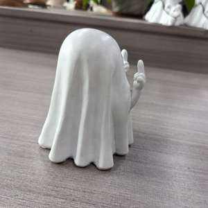 Detailed back view of a white ghost ornament showing a creative middle finger gesture