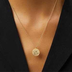 Vintage stainless steel gold coin necklace with nature elements on elegant model