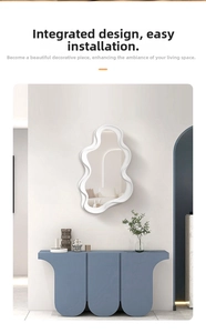 Close-up of cloud-shaped wavy mirror with white frame mounted on a minimalist wall