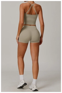 Detailed back view of criss-cross yoga vest and high-waisted shorts in sage green