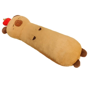 Brown capybara long plush pillow with a red fruit accent on a clean white background