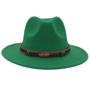 Detail of green wool jazz hat featuring a brown band and a gold feather metal pendant