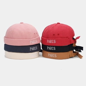 Flat lay of Paris embroidered docker hats in six colors with adjustable straps