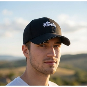 Detail of black baseball cap with 3D Amike embroidery and Sport printed on the brim