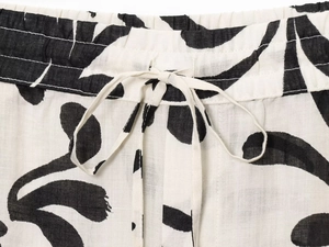 Detail of drawstring elastic waistband on black and white floral print trousers