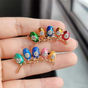Set of two colorful enamel bird hair clips with rhinestones on golden branches