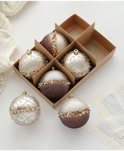 Detailed view of champagne and coffee glitter Christmas balls in a gift box