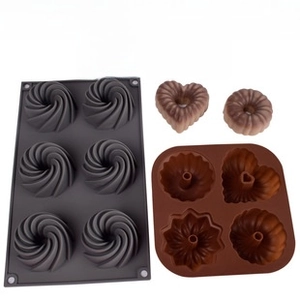 Detail of 7-hole silicone pancake molds showing various spiral and heart patterns