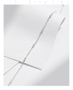 Detail of s925 silver chain bracelet featuring sparkling cubic zirconia on a white surface