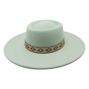 Detailed view of pale mint wool felt boater hat with geometric embroidered ribbon
