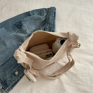 Large beige corduroy tote bag with small round pouch showing spacious interior storage